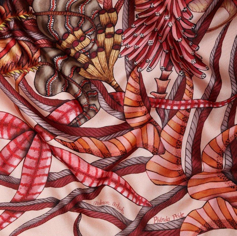 A zoomed-in section showcasing intricate jungle leaves and vines in deep reds and warm tones.