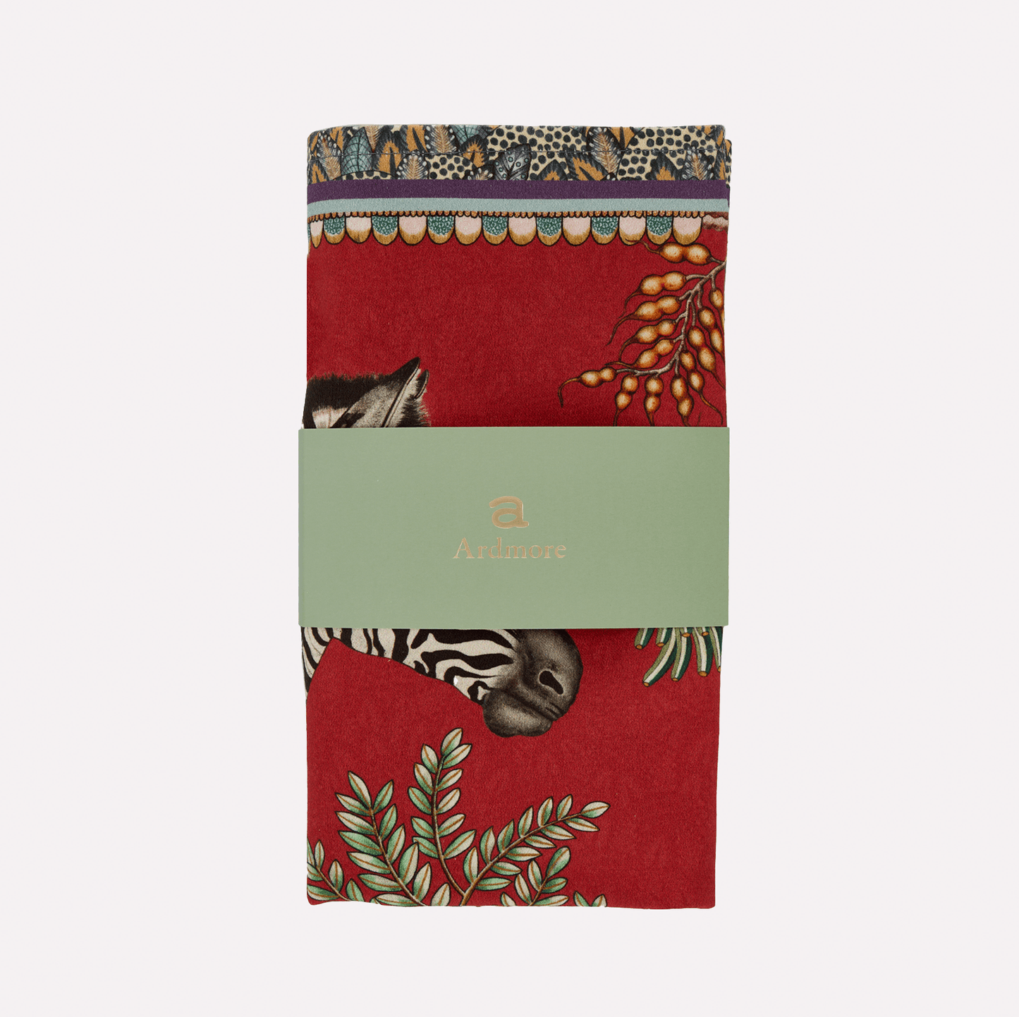 A neatly folded and packaged Ardmore Thanda Stripe Napkin in Royal Red, wrapped in branded paper showcasing its premium cotton fabric and exquisite craftsmanship.