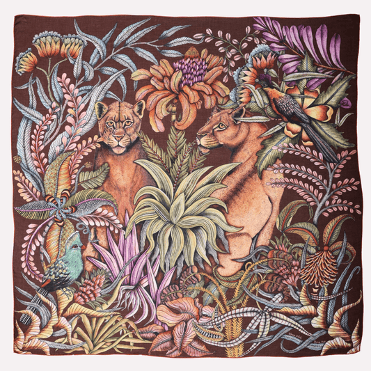 A square scarf in deep mahogany hues, featuring an intricate African wildlife scene with two lionesses surrounded by lush foliage.