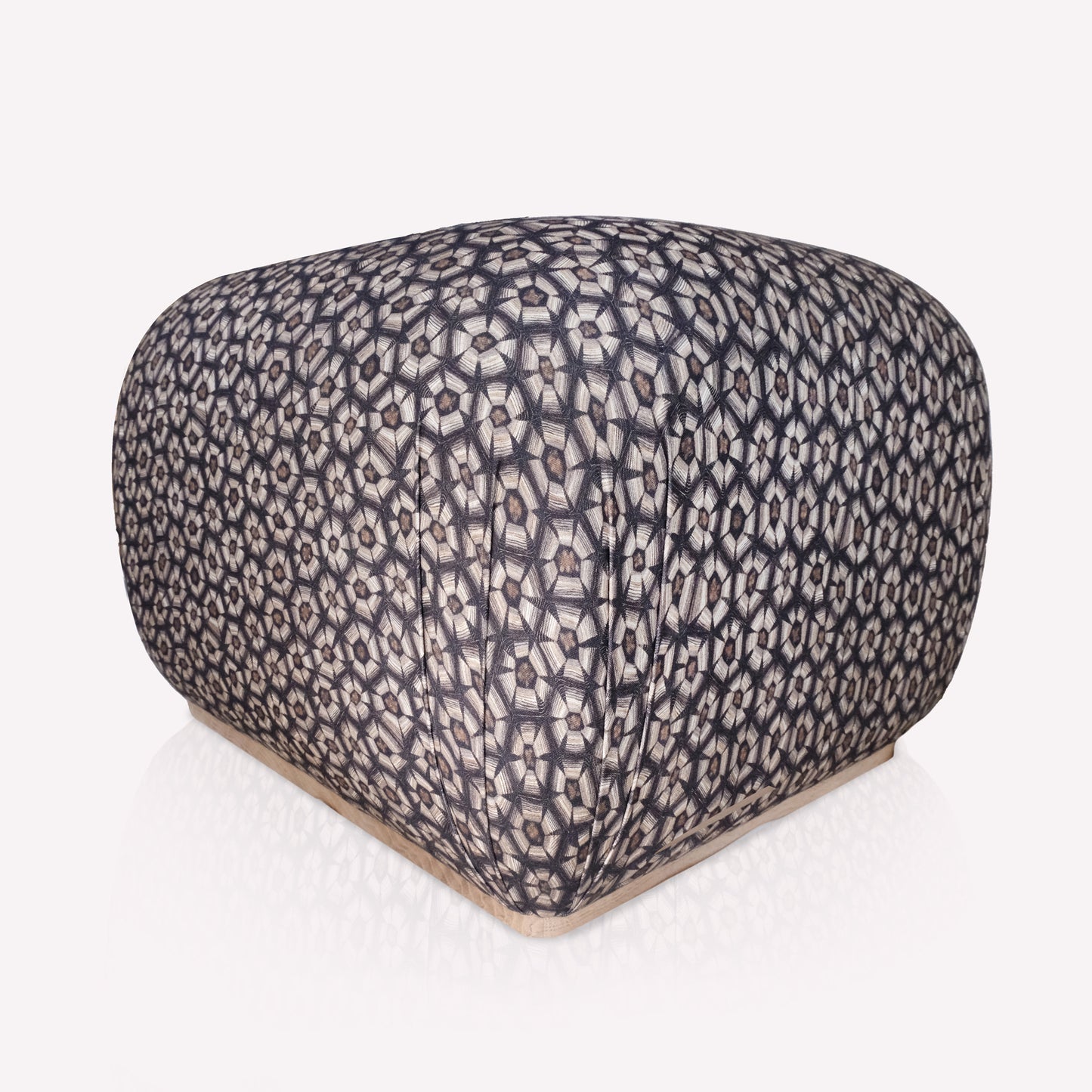 A different angle of the Nyala Ottoman, showcasing its elegant curves and intricate woven fabric texture. The monochromatic tortoise-shell motif adds a touch of African-inspired luxury and artistic craftsmanship.