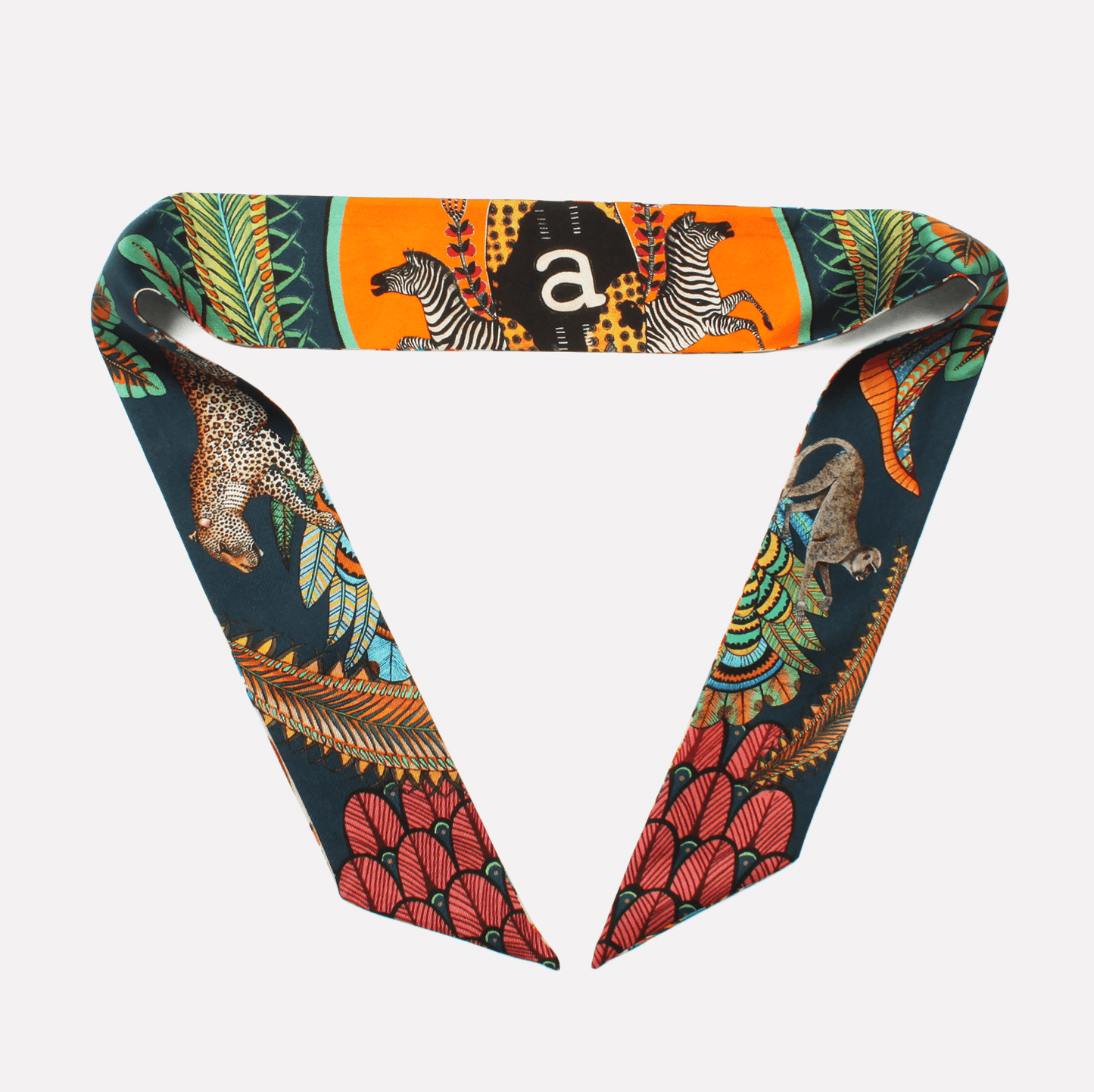 The same silk twill ribbon styled into a chic loop, showcasing its bold colours and detailed patterns, perfect for elegant accessorising.