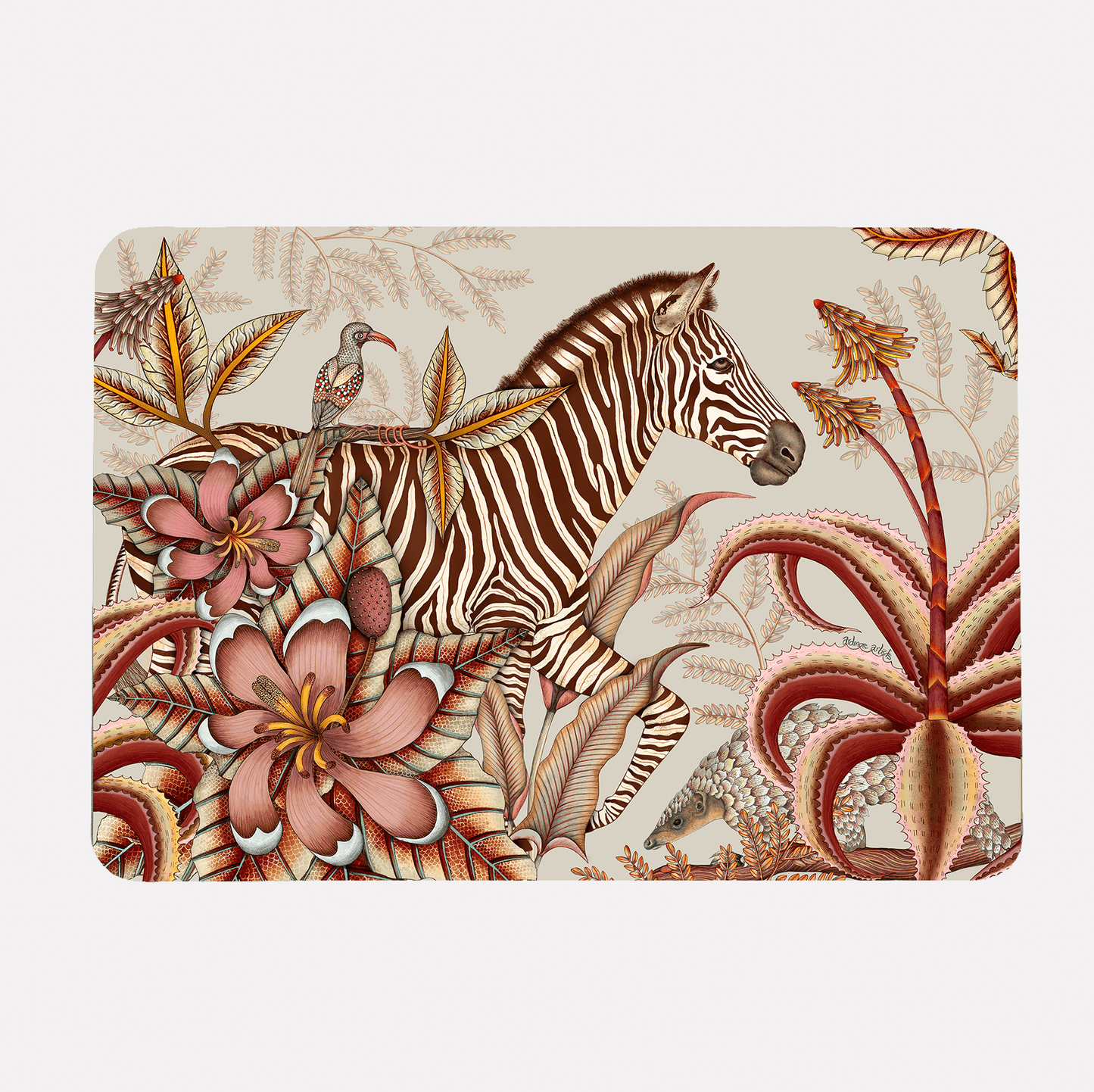 A hardboard placemat featuring a zebra surrounded by lush magnolias, flowering aloes, and intricate foliage on a soft plum background.