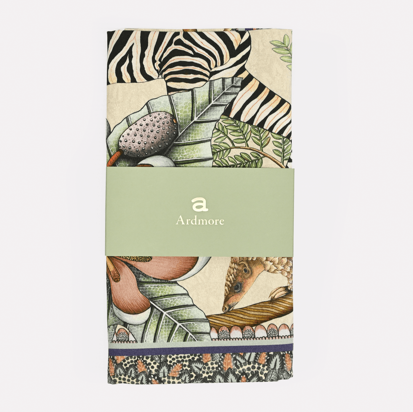 The Ardmore Thanda Stripe Napkin in Stone, neatly folded and wrapped with branded packaging, showcasing its premium quality.