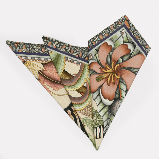 A folded Ardmore Thanda Stripe Napkin in Stone, showcasing intricate floral and wildlife-inspired patterns in soft neutral tones.