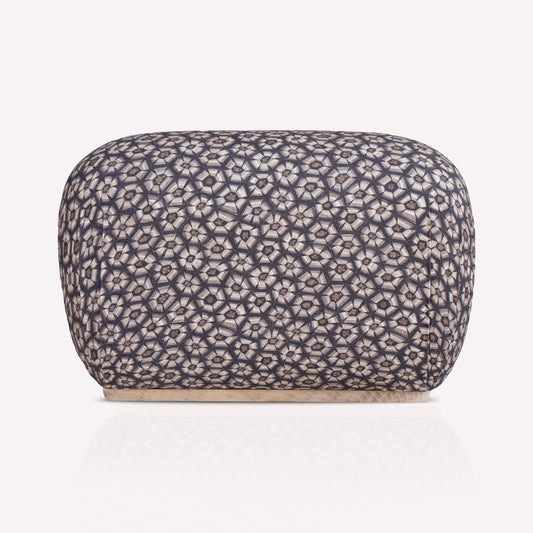A luxurious Nyala Ottoman with a refined tortoise-shell pattern in silver and charcoal hues. The ottoman has a smooth, rounded rectangular shape, providing a plush and sophisticated seating or decorative element.