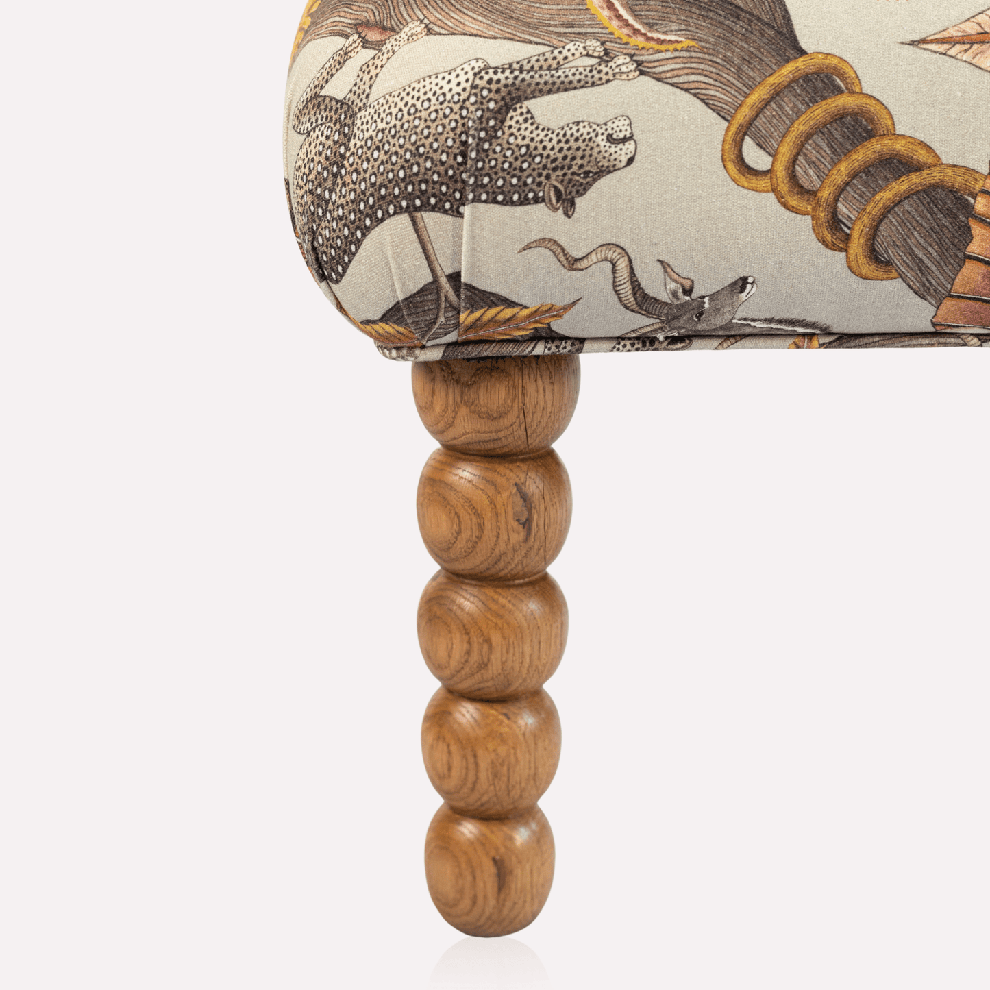 Close-up of the Ardmore Kudu Pod Chair’s wooden legs and detailed fabric texture, showcasing the refined craftsmanship and opulent Pangolin Plum Velvet material