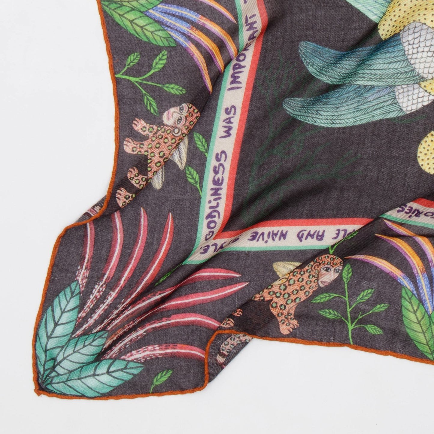 A detailed view of the scarf’s hand-stitched edges with a branded trim, emphasising craftsmanship and quality.