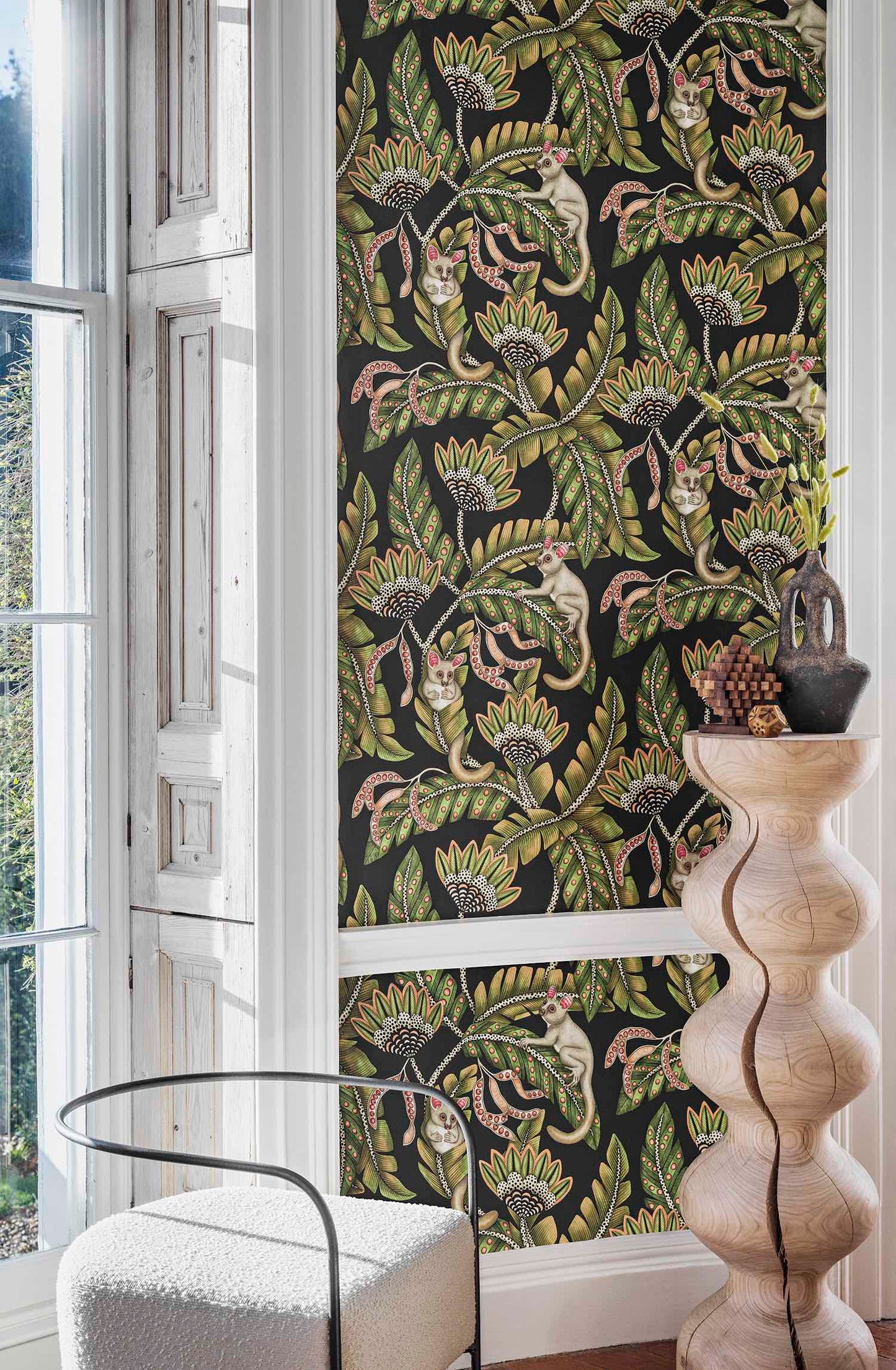 A refined interior where the wallpaper is elegantly paired with a sculptural wooden vase, highlighting its rich, inky background.