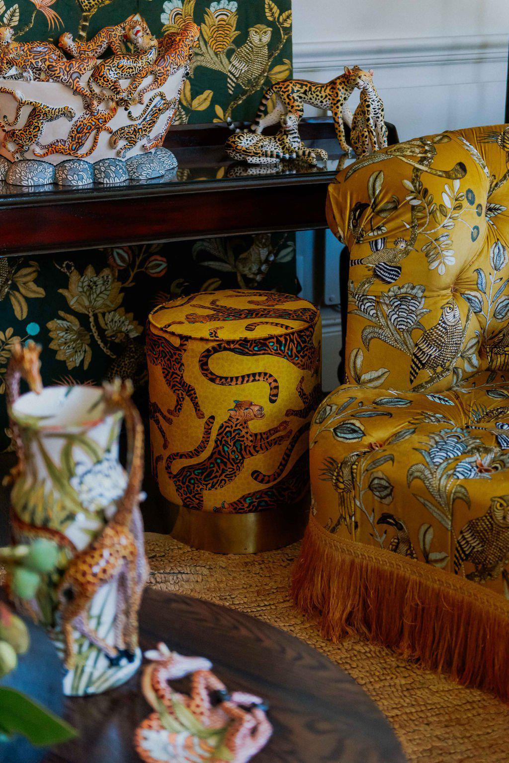 In-store display of the Ardmore Cheetah Kings Gold Velvet Pouffe, surrounded by other luxurious home decor pieces, emphasising its regal and sophisticated appeal.