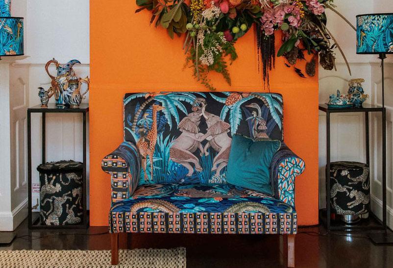 Interior setting showcasing the Ardmore Cheetah Kings Starry Nights Velvet Pouffe in a stylish living space, blending African-inspired artistry with contemporary luxury decor.