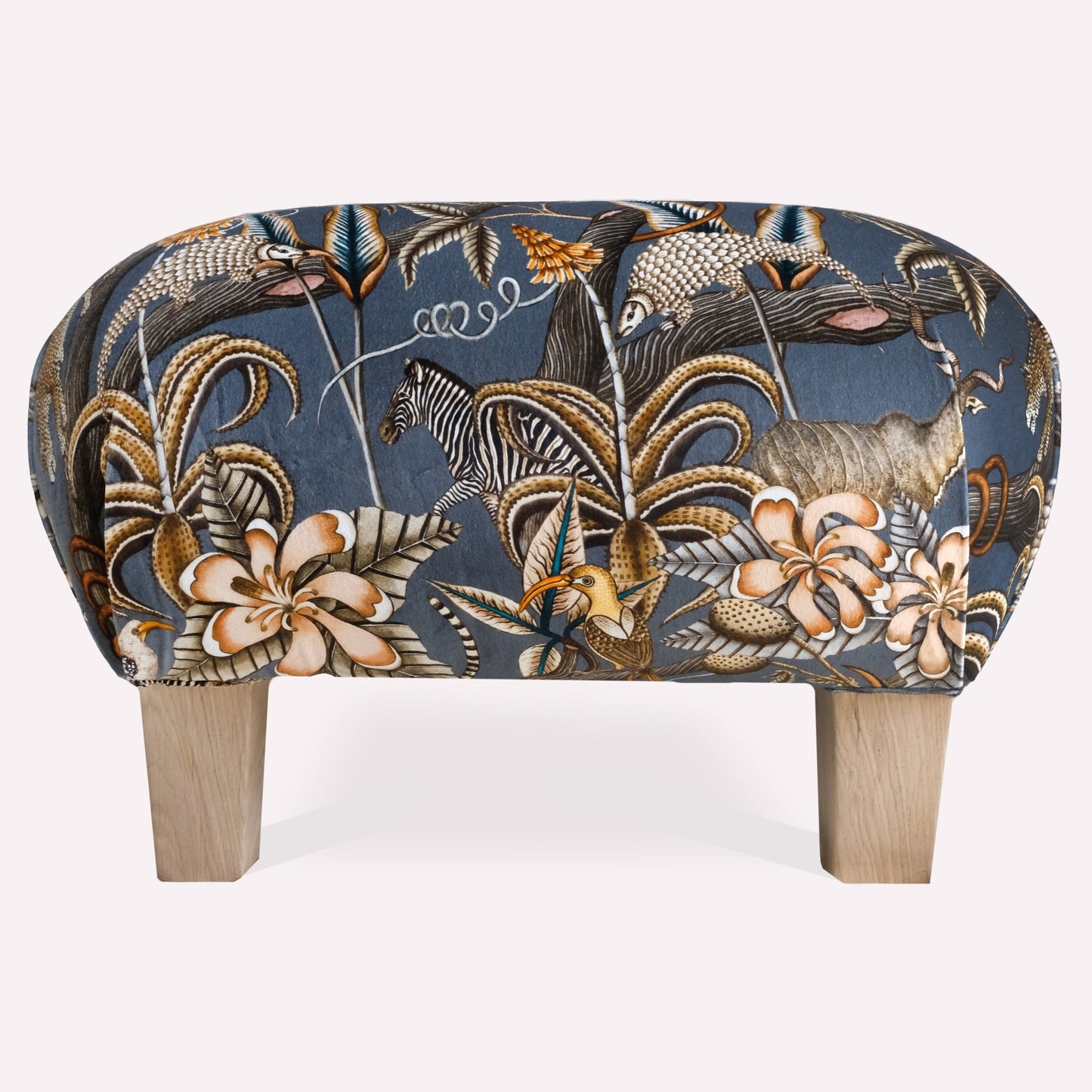 A detailed shot highlighting the exquisite craftsmanship, rich velvet texture, and intricate pattern inspired by African wildlife and foliage.