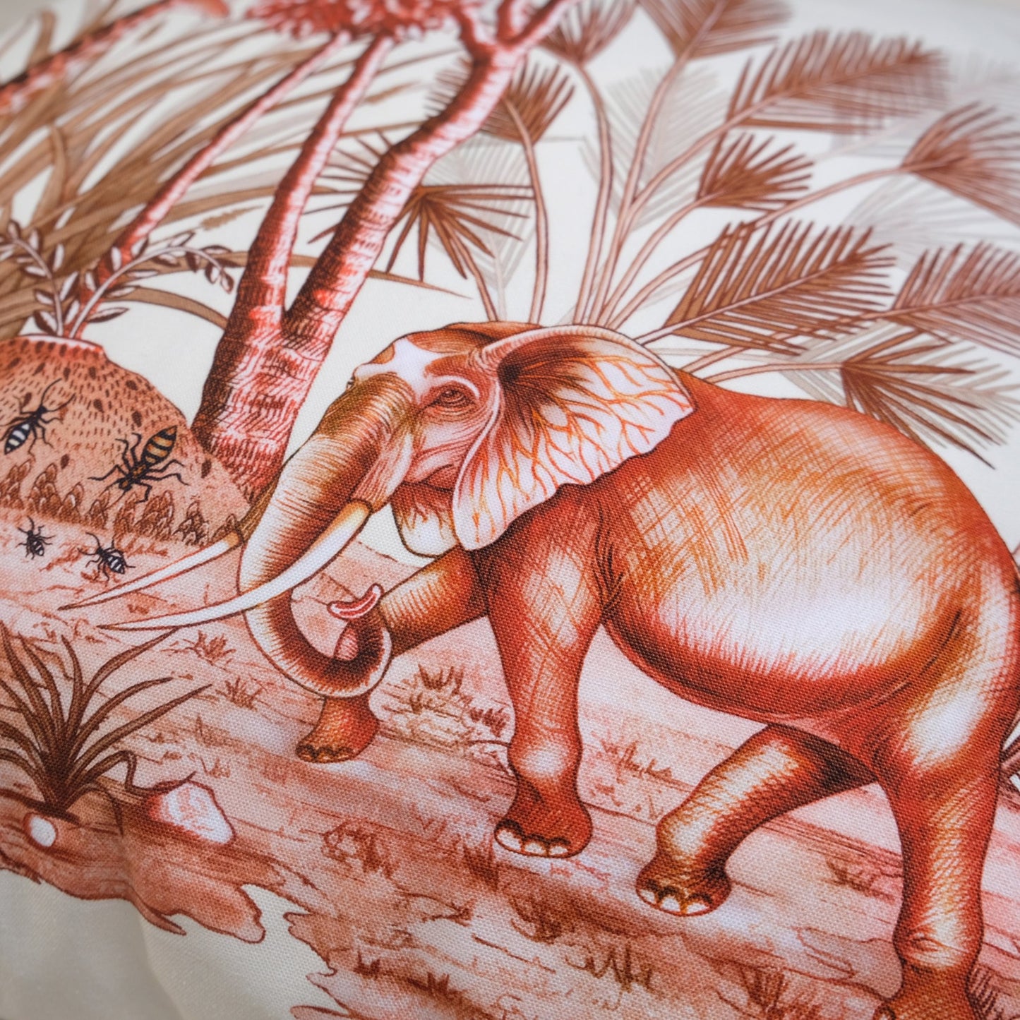 A close-up of an elephant among lush African plants, emphasising the elegant plum colour scheme and artistic design.