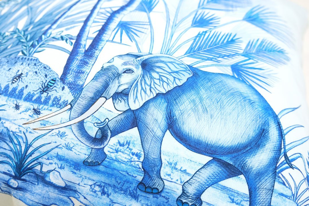 A zoomed-in section of the cushion featuring a giraffe surrounded by African trees, demonstrating the intricate toile pattern.