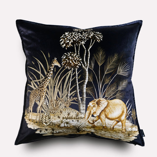 Front view of the Thanda Toile Night Velvet Cushion Cover, featuring a rich black background with an intricate toile design of African wildlife, including an elephant resting under trees.