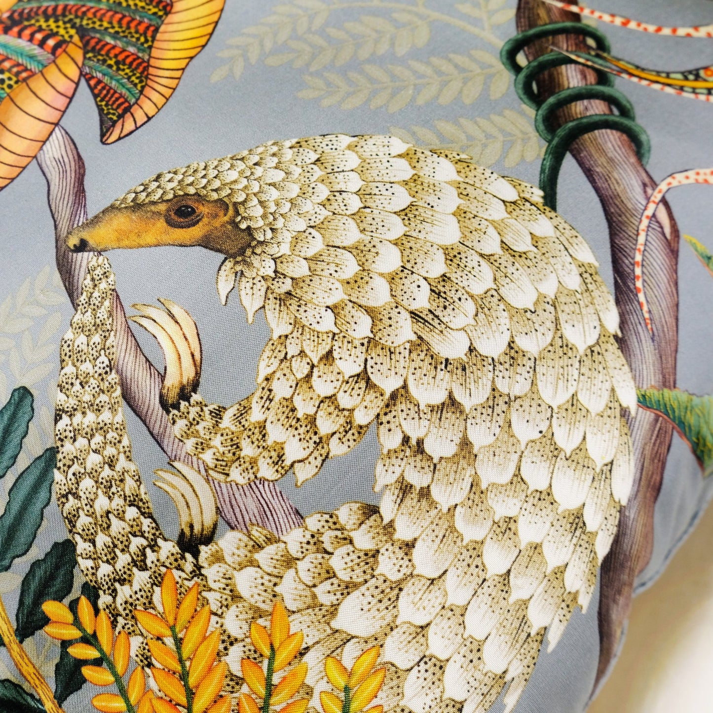 Detailed view of the pangolin design on the Thanda Pangolin in Ash Silk Cushion Cover, focusing on the artistic pattern and vibrant accents.