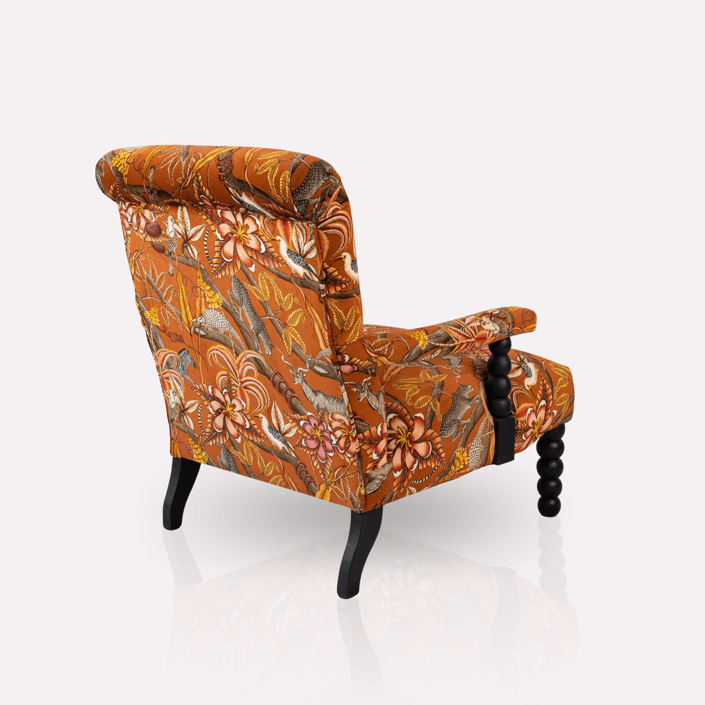 Close-up of the Ardmore Kudu Pod Chair in Pangolin Park Rust Velvet, revealing the intricate African-inspired textile pattern and rich texture.