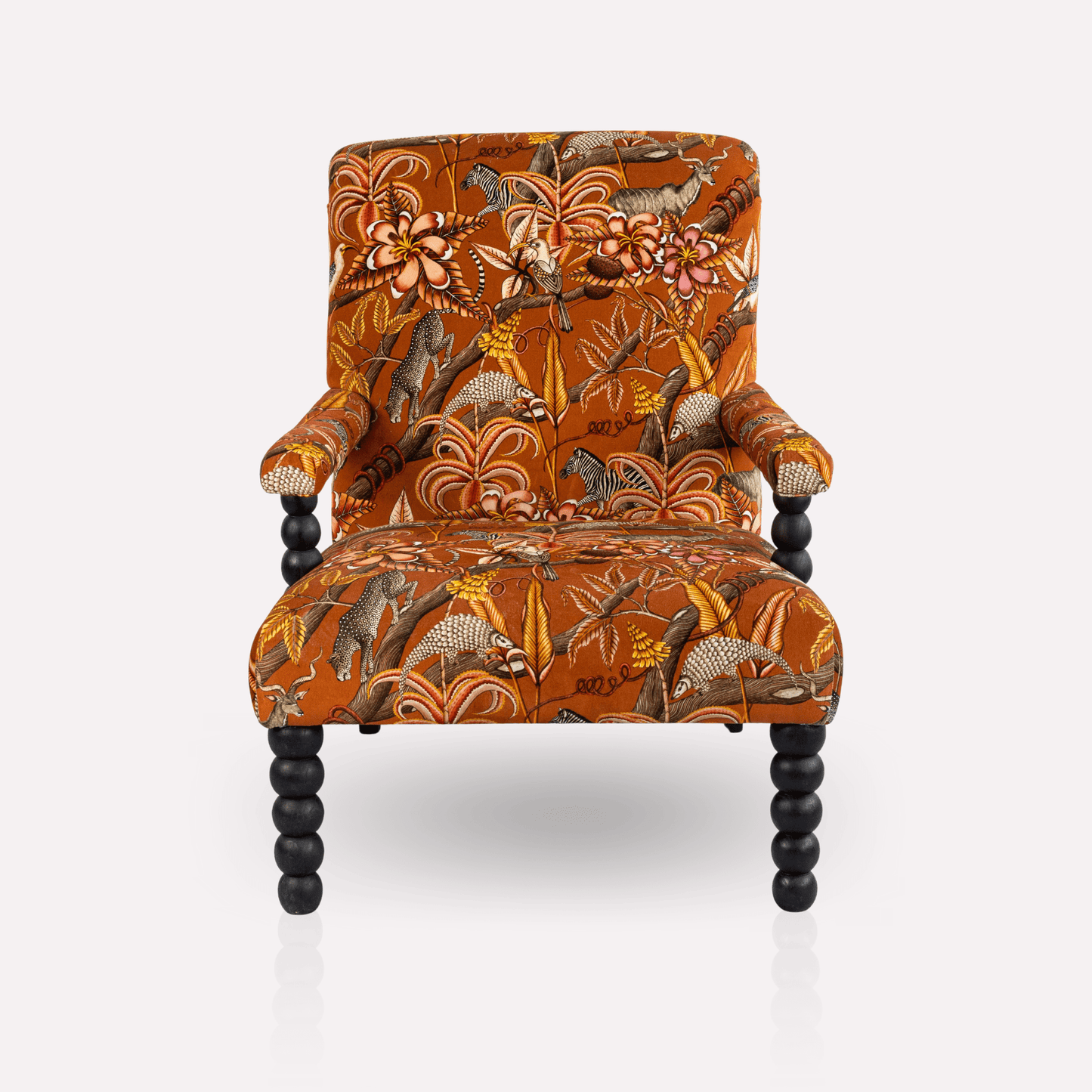 Front view of the Ardmore Kudu Pod Chair in Pangolin Park Rust Velvet, showcasing its high backrest, deep seat, and luxurious upholstery.