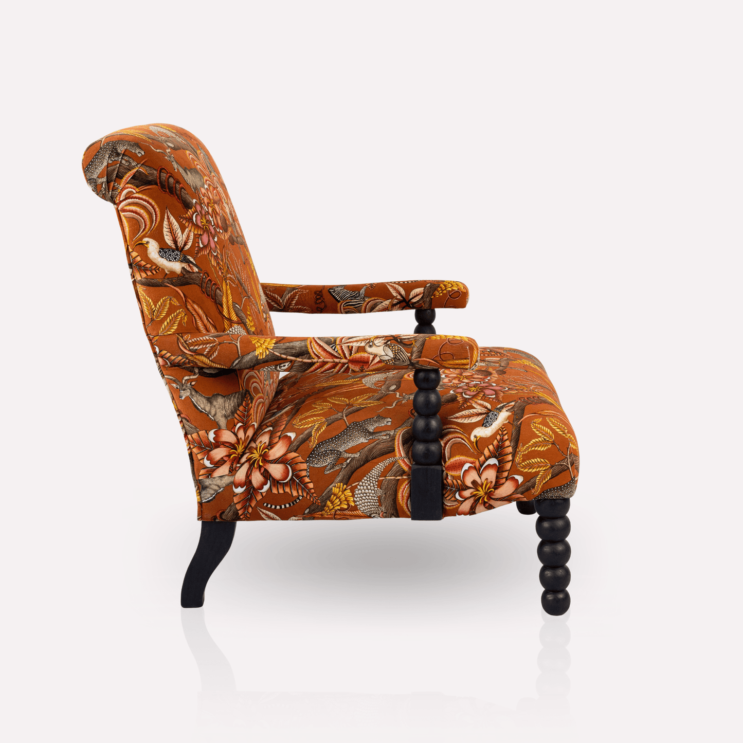 Side profile of the Ardmore Kudu Pod Chair in Pangolin Park Rust Velvet, displaying the plush armrests, ergonomic seat, and refined design.