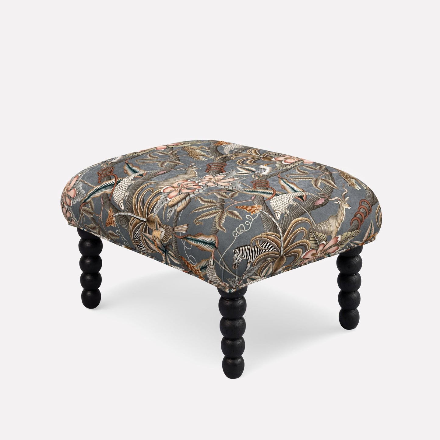 Ardmore Kudu Pod Ottoman in Ash Velvet, featuring a rich dark botanical print with elegant black spindle legs, blending African-inspired artistry with contemporary luxury.