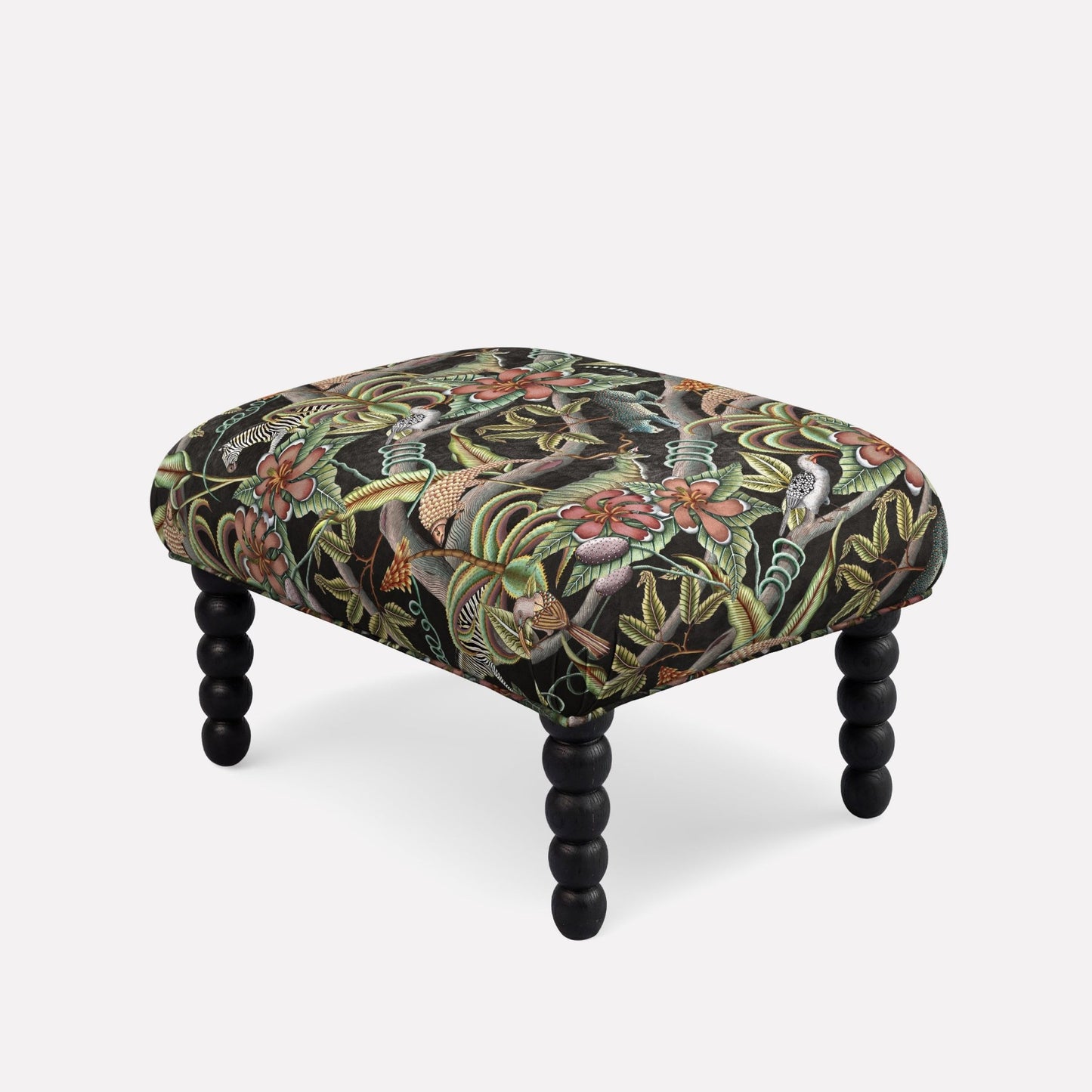 Ardmore Kudu Pod Ottoman in Pangolin Park Night Velvet, featuring a dark botanical pattern with rich foliage and black spindle legs, blending African-inspired luxury with modern elegance.