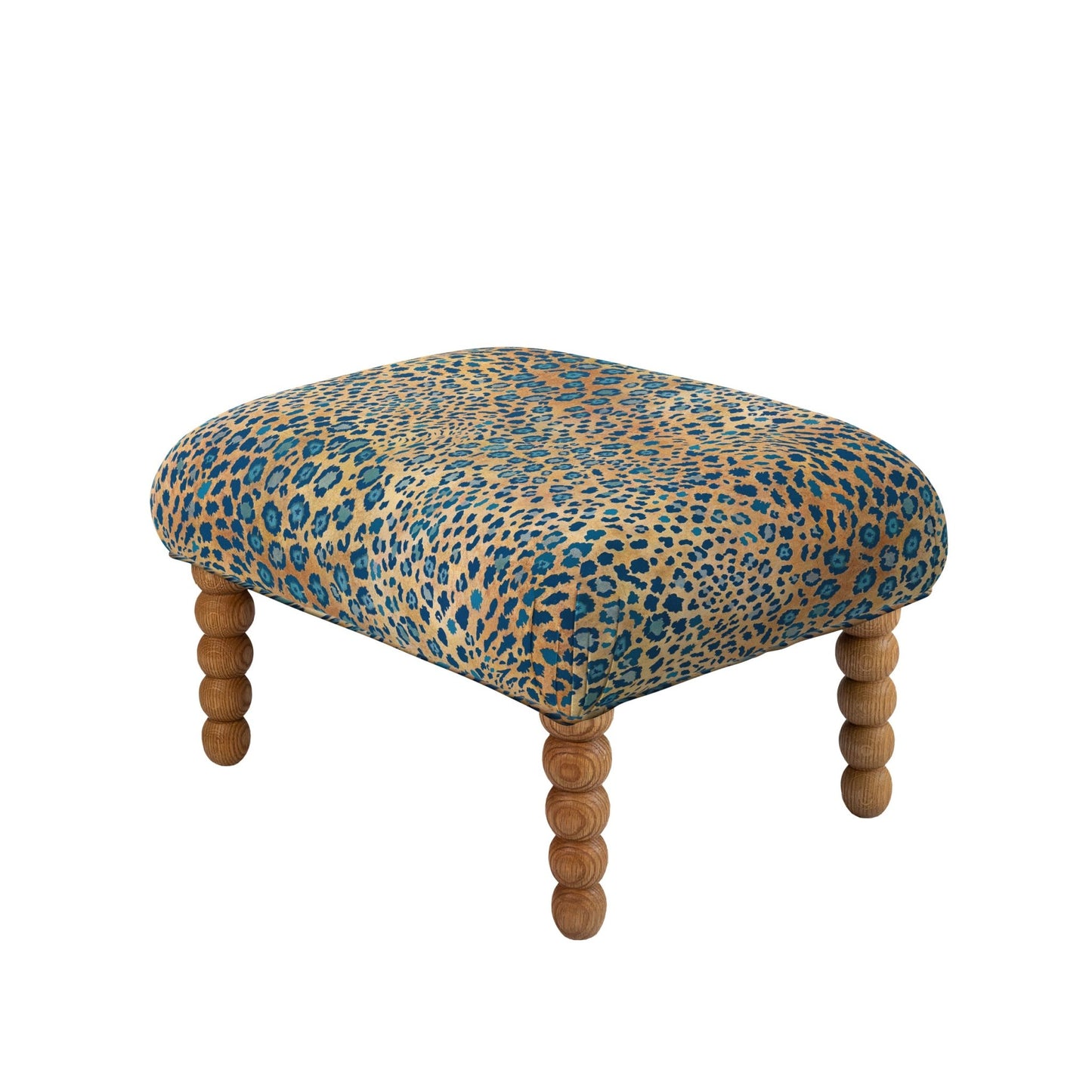 A luxurious Kudu Pod Ottoman from Ardmore, upholstered in Safari Spot Midnight Linen. The graceful silhouette and patterned fabric create an opulent yet versatile statement piece.