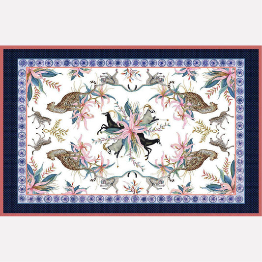 A flat lay of the Leopard Lily Tablecloth in Frost, featuring an intricate design of zebras, leopards, and florals bordered in deep blue and red hues.