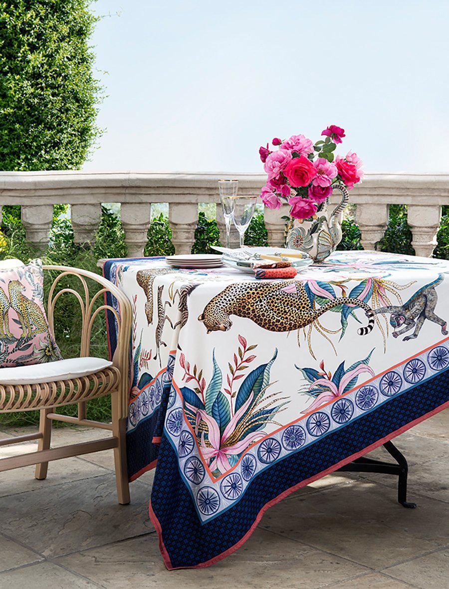Outdoor dining setup showcasing the Lovebird Leopards Magnolia Cushion Cover and matching tableware for a cohesive look.