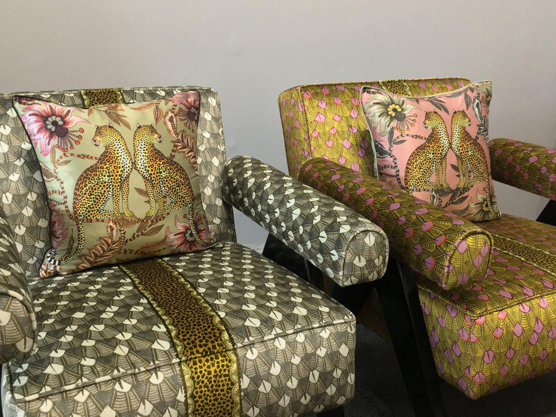 Decorative arrangement of multiple Lovebird Leopards Magnolia Silk Cushion Covers on a seating area, enhancing a luxurious interior setting.