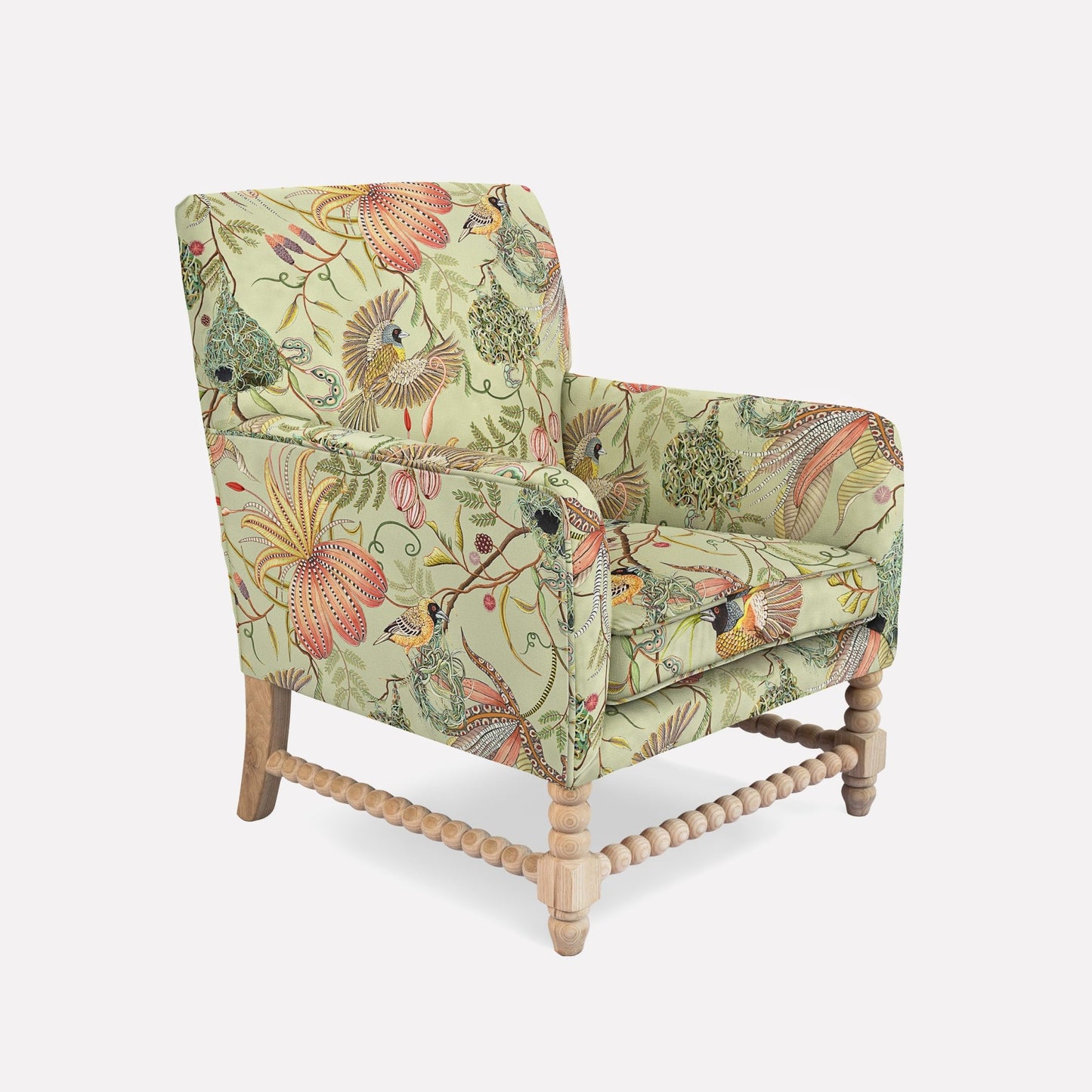 A side-angle view of the Lucky Bean Chair, showcasing its solid wooden legs and intricate fabric detailing. The soft cream-toned linen upholstery is enriched with vivid floral and fauna motifs, seamlessly blending African-inspired craftsmanship with modern sophistication.