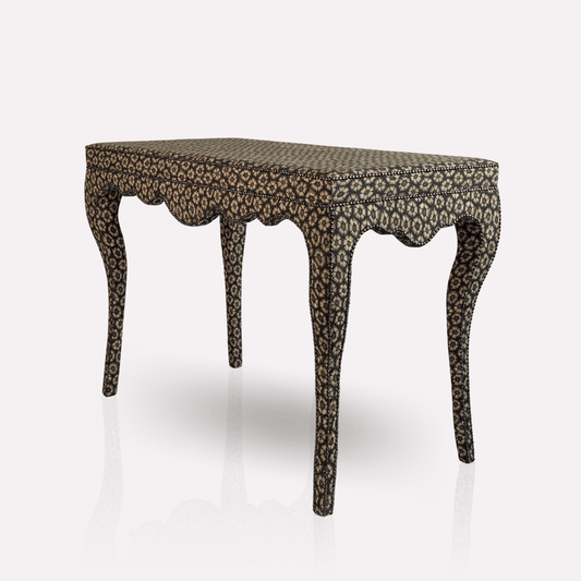 A luxurious Nyala Table from Ardmore, crafted with Thanda Tortoise Silver Linen fabric. The elegantly curved legs, inspired by Nyala antelope horns, and the intricate fabric pattern create a striking centrepiece for refined interiors.