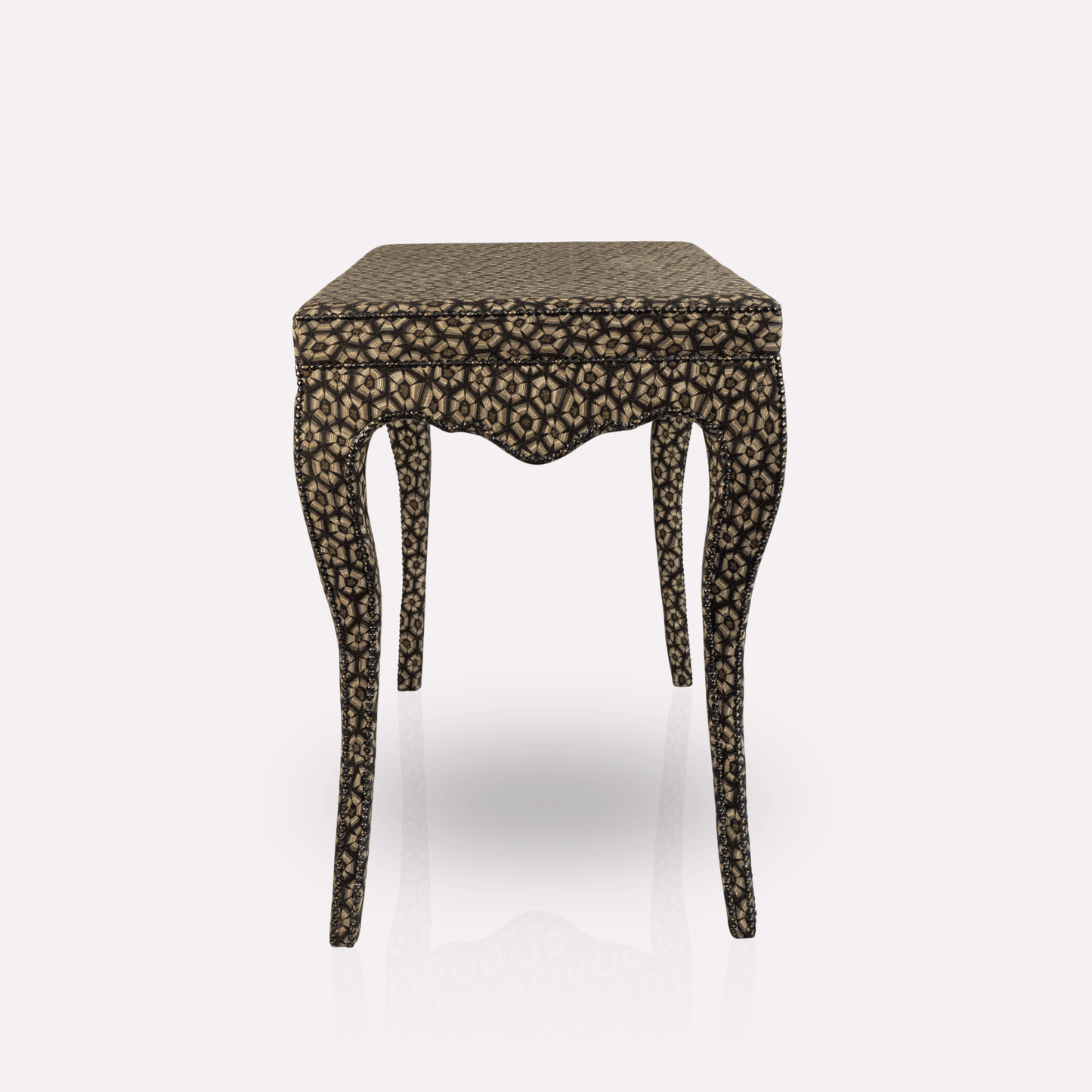 A detailed close-up of the table’s upholstery, revealing the intricate tortoise-shell pattern woven into luxurious linen and viscose fabric.