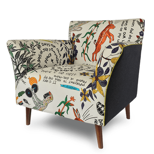 A three-quarter angled shot displaying the chair's structured armrests, plush cushioning, and detailed upholstery, offering a better perspective on its artistic fabric design.