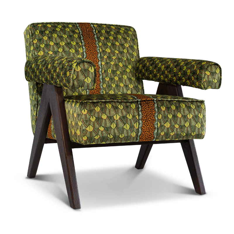 A three-quarter angle shot, showcasing the chair’s structured silhouette, plush armrests, and modern wooden legs.