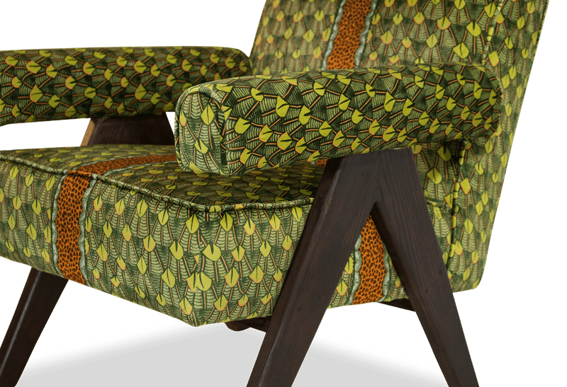 A side perspective of the chair, highlighting its sleek proportions, elegant upholstery, and the seamless integration of fabric and wood.