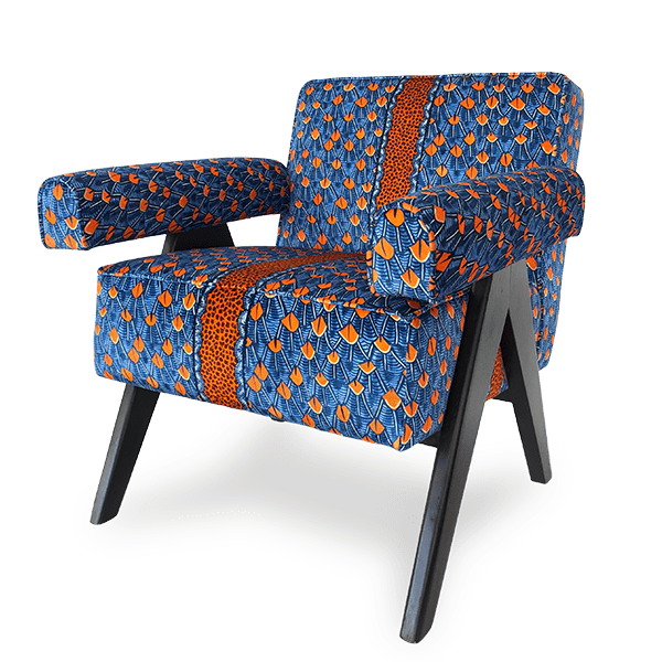 A three-quarter angled view of the chair, showcasing its plush cushioning, curved armrests, and sleek black wooden legs, highlighting its elegant and modern silhouette.