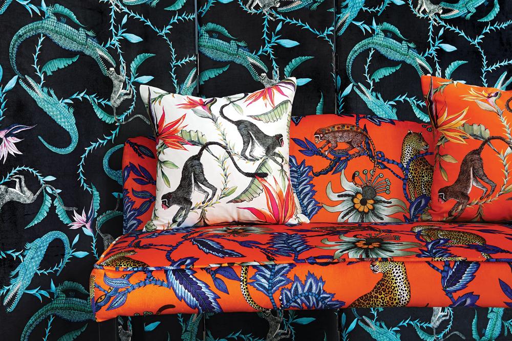 A detailed shot of the Monkey Bean Flame fabric, highlighting the intricate African motifs, bold colour contrast, and the luxurious velvet texture that adds depth to the design.