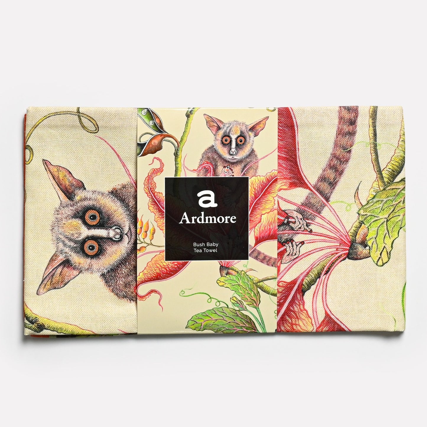 The tea towel in its original packaging, displaying the high-quality craftsmanship and iconic African-inspired design.