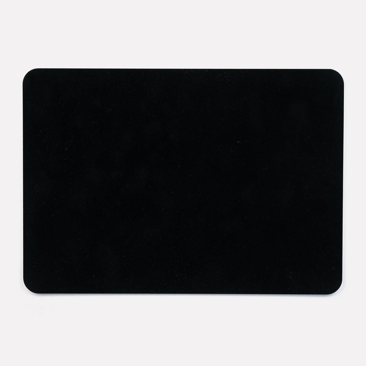 A solid black back of the placemat, showcasing its sleek and durable hardboard finish.