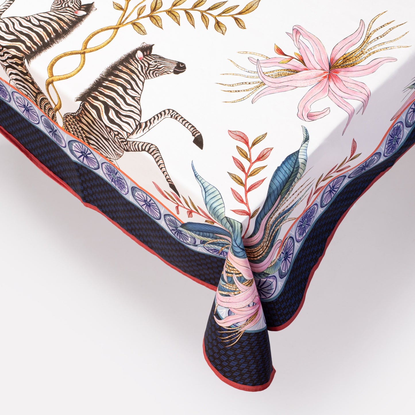A detailed close-up highlighting the fine illustration of a zebra, surrounded by intricate florals along the fabric border.