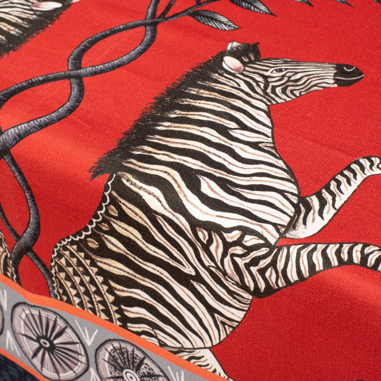 A macro shot of a zebra design on the fabric, capturing the fine detailing and contrast between the bold red and the monochrome animal print.