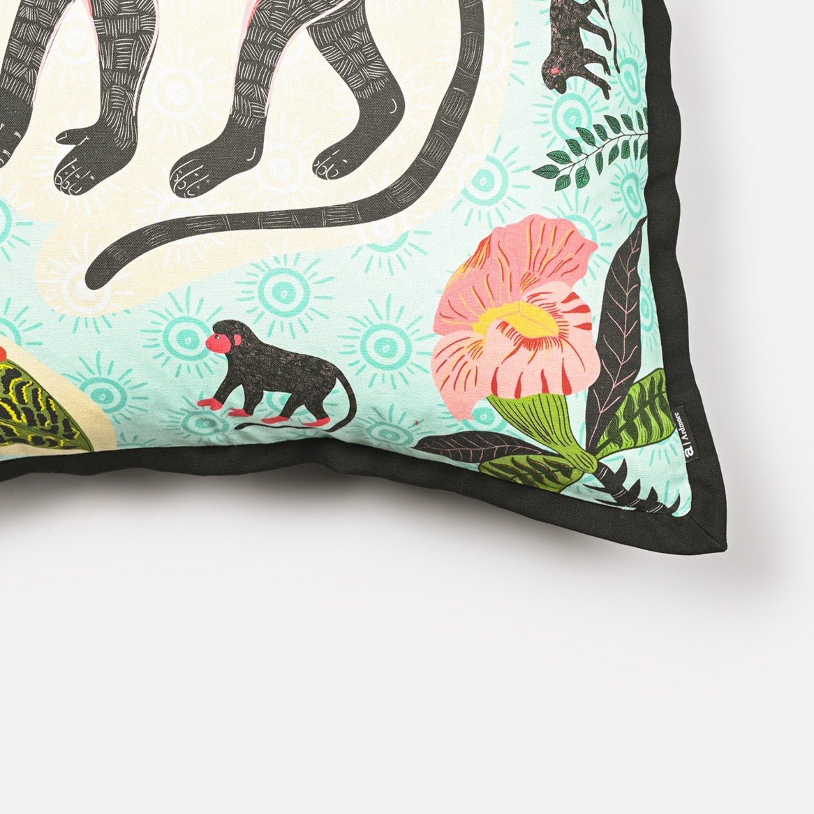 Angled side view of the Meandering Monkey Oasis cushion cover highlighting the detailed monkey and floral patterns.