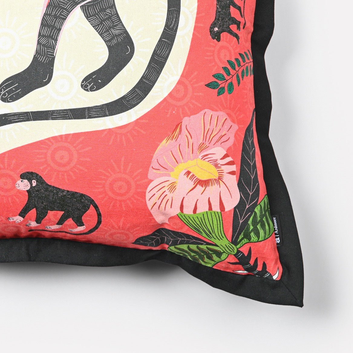 Close-up of the Meandering Monkey Sunset Cushion Cover's intricate monkey design and colourful floral accents, emphasising the detailed craftsmanship.