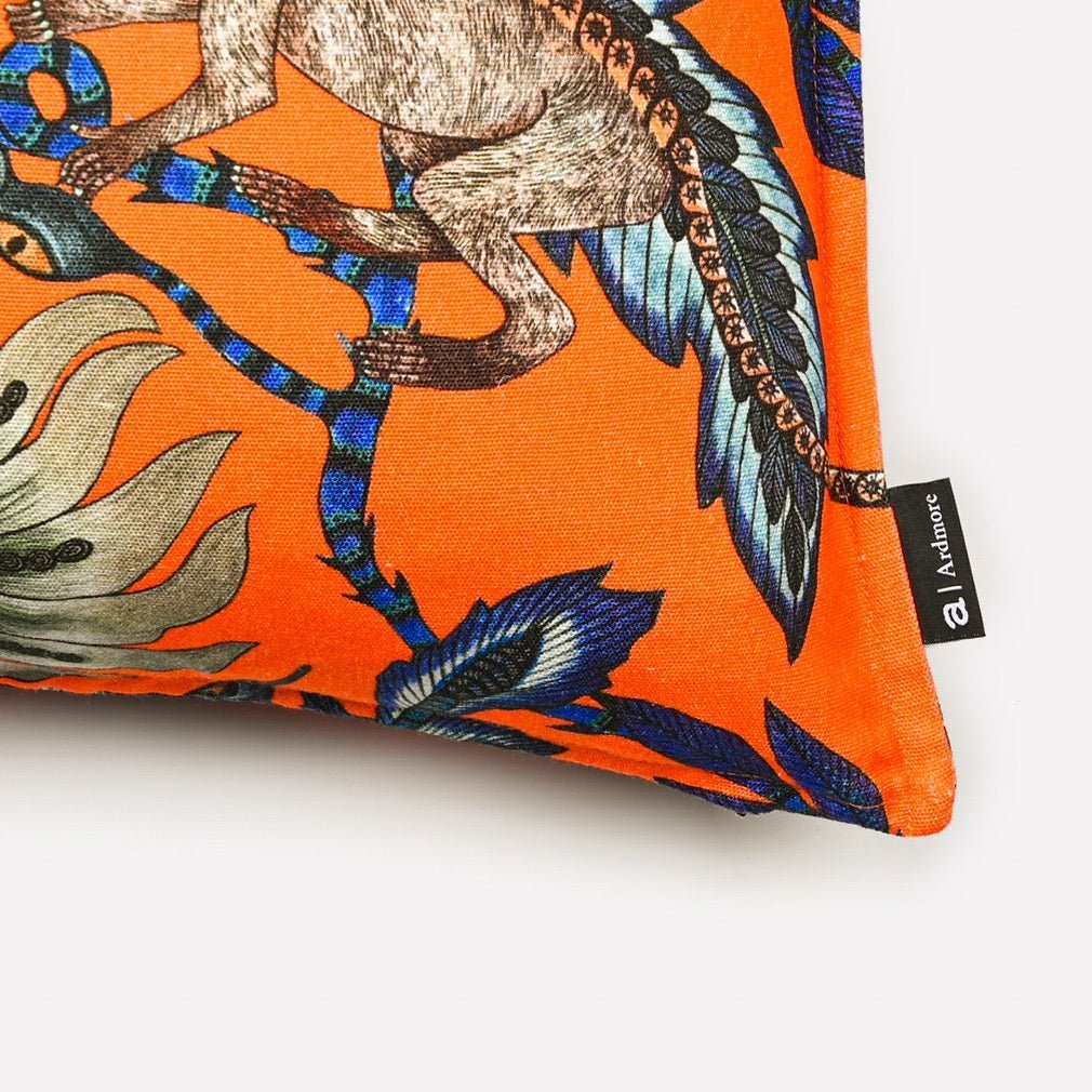 Close-up view of the Monkey Bean Flame Linen cushion cover, highlighting detailed cheetah illustrations and bold floral accents.