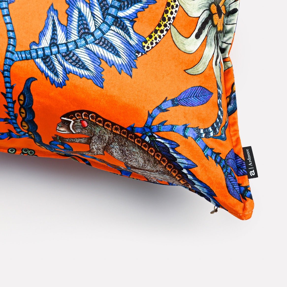 Close-up of the Monkey Bean Flame cushion cover, focusing on the fine texture and bold orange and blue patterns.