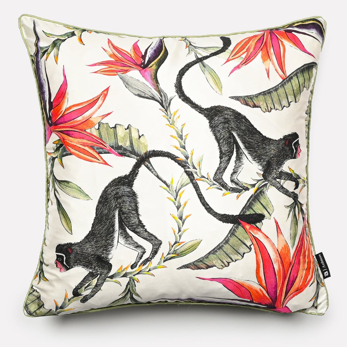Printed silk cushion cover featuring a lively tropical design with monkeys and vibrant foliage in chalk colour, displayed against a white background.