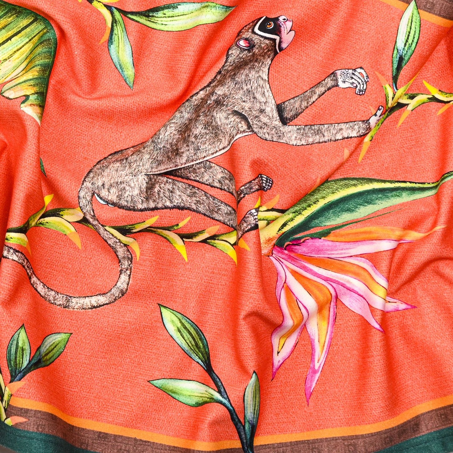 A zoomed-in section highlighting the fine artistic detailing of exotic animals and floral elements on the fabric.