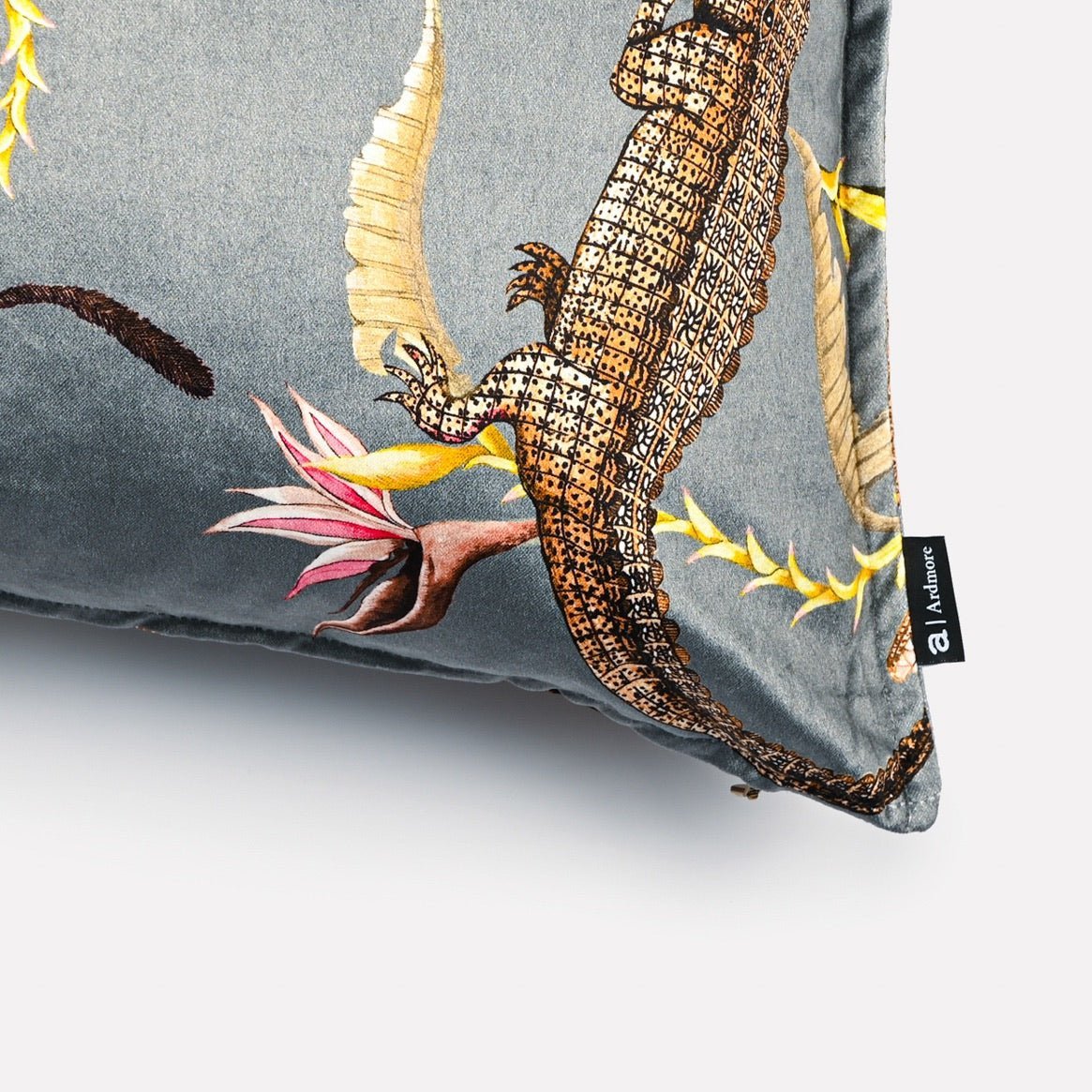 Close-up of the intricate details on the River Chase Silver Ripple Velvet Cushion Cover, highlighting the alligator motif and vibrant foliage accents.