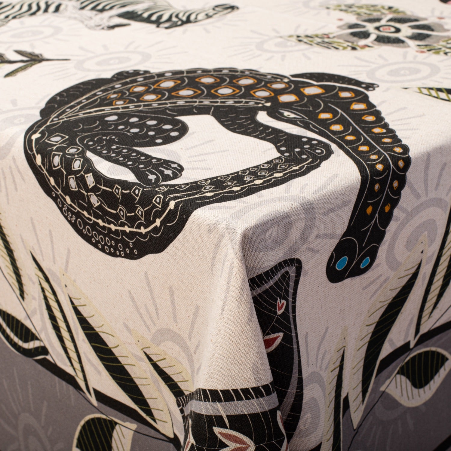 A detailed macro shot of the leopard design, highlighting the contrast between the rich black print and the natural linen fabric.