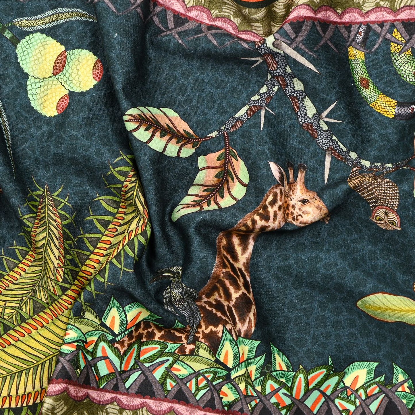 A zoomed-in view of the table runner, featuring a carefully illustrated scene with tropical foliage and exotic animals, showcasing the intricate craftsmanship.