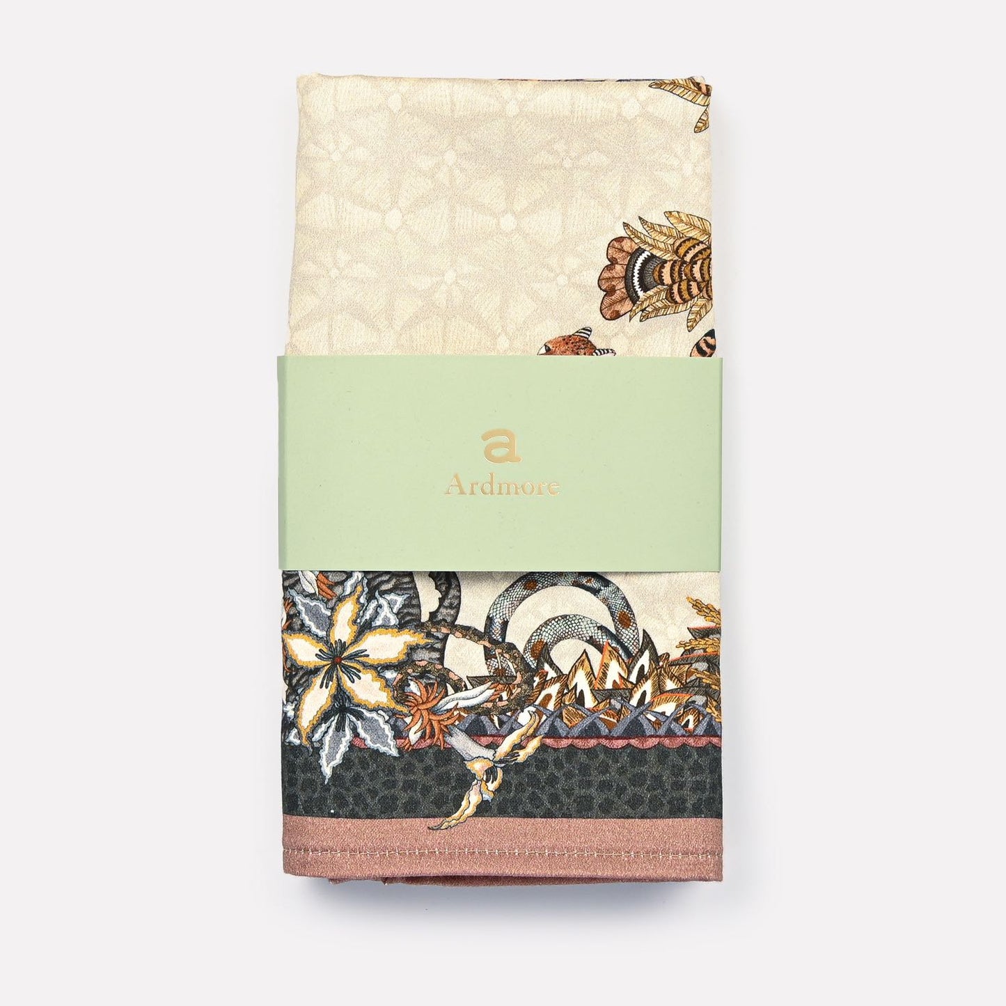 A neatly folded and packaged Ardmore Sabie Forest Napkin in Stone, wrapped with a branded paper band, displaying the elegance and refined craftsmanship of the collection.